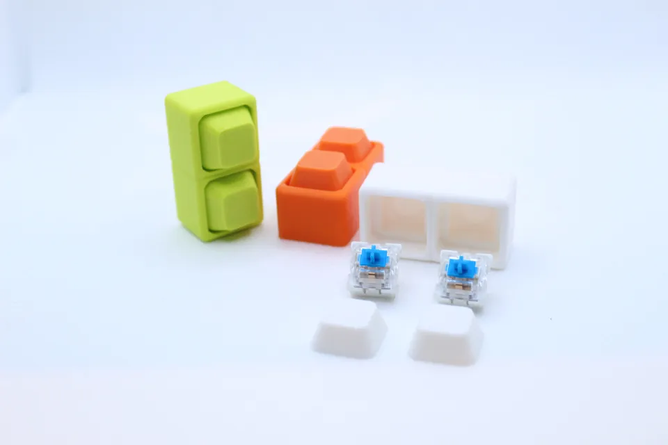 Keycap-style clicker fidgets in green and orange