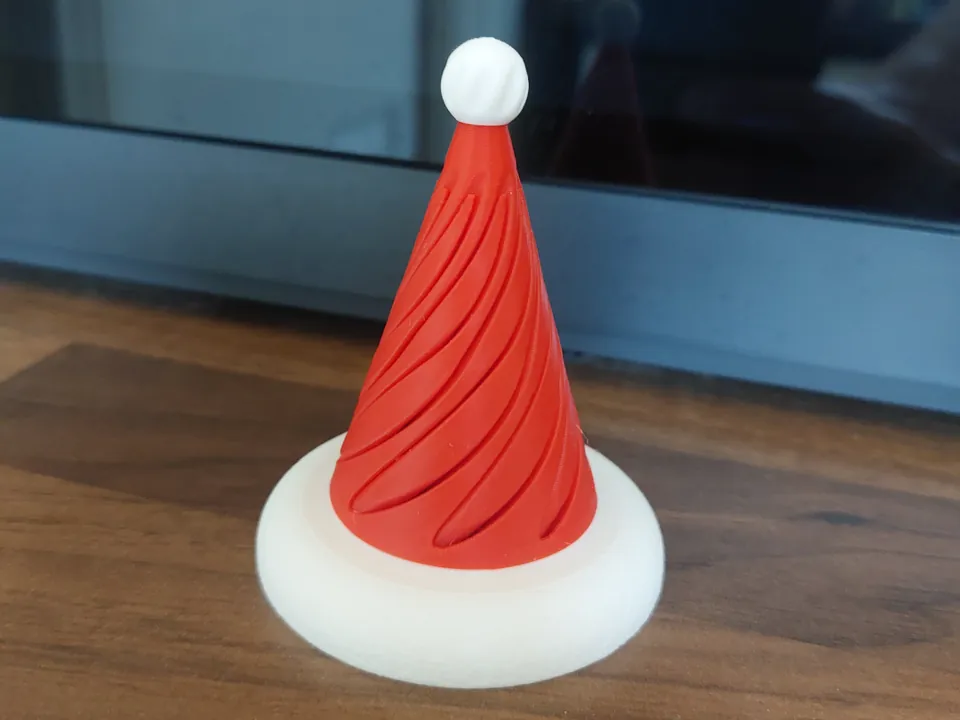 Red and white spiral fidget shaped like a Santa hat